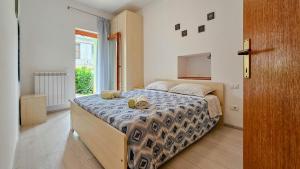 a bedroom with a bed and a large window at Zigante in Novigrad Istria