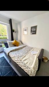 a bedroom with a bed in a room with a window at LE COSY studio proche PARIS avec parking & terrasse in Courcouronnes