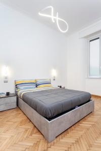a bedroom with a large bed in a white room at Stazione Centrale-Ariel Soperga32 in Milan
