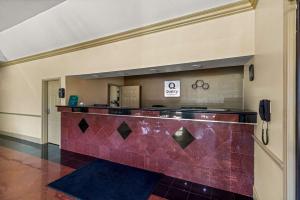a lobby with a red tile counter in a building at Quality Inn Bay City TX in Bay City