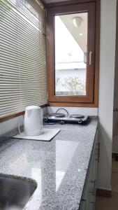 a kitchen counter with a sink and a window at Refugio Sureño departamento completo centrico wifi in Ushuaia +23 photos