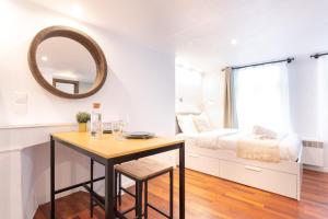 Habitación con mesa, cama y espejo. en Old Lille - studio ideally located !, en Lille