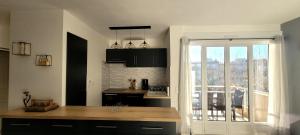 a kitchen with a counter and a window with a view at Appart T3 a 50 m de la plage in Cavalaire-sur-Mer +26 photos