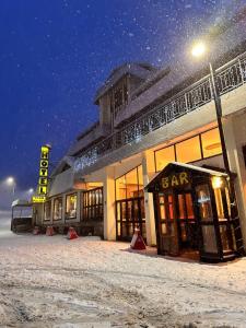 a building in the snow at night at Hotel Togo Monte Terminillo in Terminillo