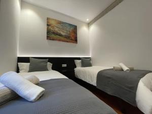 ein Schlafzimmer mit 2 Betten und einem Wandgemälde in der Unterkunft Sarrikobaso House in Getxo