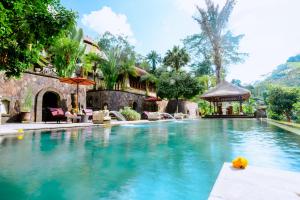 a swimming pool at a house with a resort at Bagus Jati Health & Wellbeing Retreat in Tegalalang