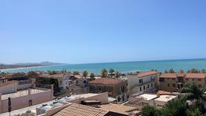 a city with buildings and the ocean in the background at Casa Magrè in Agrigento