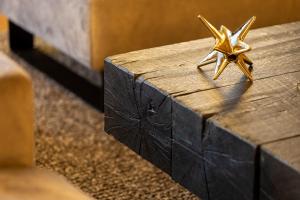 two gold stars sitting on top of a wooden box at Hotel Meta Resort & Vine SPA in Szczyrk