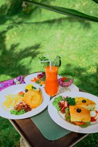 a table with two plates of food and a drink at Bagus Jati Health & Wellbeing Retreat in Tegalalang
