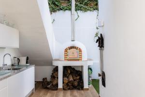 a kitchen with an outdoor oven in the corner of a room at Atmosphere Luxury Townhouse with Private Pool in La Herradura