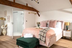 a bedroom with a large bed with a green ottoman at Stargaze in Blandford Forum