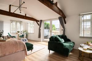 a bedroom with a bed and a couch and a table at Stargaze in Blandford Forum