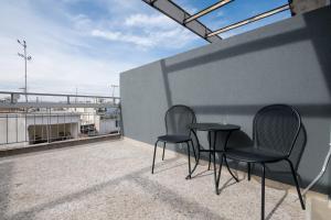 two chairs and a table on a balcony at Luxury Super Central Apartment 2 in Larisa