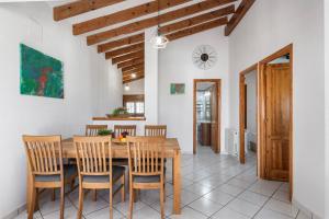 een keuken en eetkamer met een houten tafel en stoelen bij Villa Maeva - PlusHolidays in Calpe
