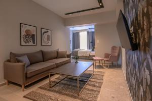a living room with a couch and a table at Luxury Super Central Apartment 2 in Larisa