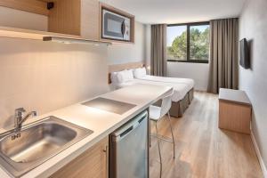 a hospital room with a sink and a bed at B&B HOTEL Barcelona Sant Cugat in Sant Cugat del Vallès