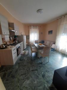 a kitchen and dining room with a table and chairs at Tindara's House in Francavilla di Sicilia
