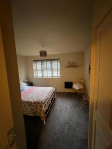 a bedroom with a bed and a window at The Shambles by Spires Accommodation A Boho styled place to stay just 3 miles from Birches Valley visitors Centre Cannock Chase in Rugeley