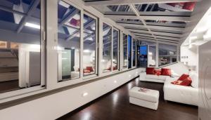 a living room with large windows and white furniture at Italianway Comfort - Torino 57 B in Milan +32 photos