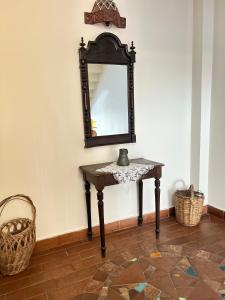 a mirror on a wall next to a table at Hotel Mirhav in Goris