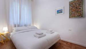 a bedroom with a white bed with towels on it at Italianway Comfort - Merlo 1 D in Milan