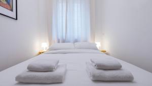 a bedroom with a white bed with two pillows at Italianway Comfort - Merlo 1 D in Milan