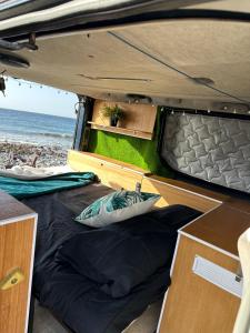 an open bed in the back of a camper van at The Blue Whale in Los Abrigos