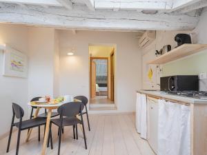 eine Küche und ein Esszimmer mit einem Tisch und Stühlen in der Unterkunft Residenza degli Artisti Apartments in Lucca