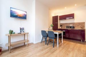 a kitchen and dining room with a table and chairs at Lille Centre - Nice ap. 4pers in Lille