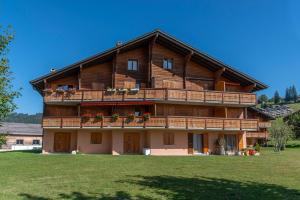 a large wooden house with a large balcony at Pic-Chaussy B14 in Les Mosses