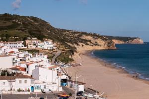 a view of a beach with white houses and the ocean at Burgau Beach House in Burgau