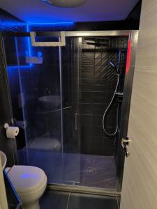 a bathroom with a glass shower with a toilet at PM 410 Via Delle Forze Armate Guest House in Milan