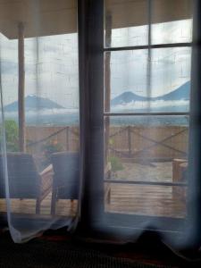 a window with a view of a deck with mountains at Khaya Nzuri 