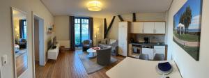 a living room with a kitchen and a living room at Strandvilla Miramare in Boltenhagen