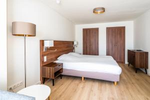 Een bed of bedden in een kamer bij Hotel Hulst