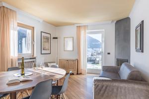 a living room with a table and a couch at Cësa Marmolada 1318 in Ortisei