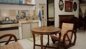 a kitchen with a wooden table and chairs in it at Budarno Homestay in Yogyakarta