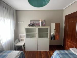 1 dormitorio con armario blanco y cama en Habitación Aeropuerto Loiu, en Loiu