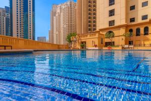 a swimming pool in a city with tall buildings at Nirvana Home in Dubai
