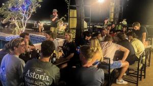 a group of people sitting at tables in a room at Mad Monkey Vang Vieng in Vang Vieng
