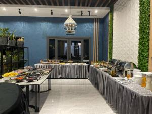 a buffet line with tables filled with food at HUSMA Hotel & Spa in Tashkent