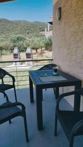 a table and chairs on a patio with a view at CASA QUERCU in Sykia Chalkidikis