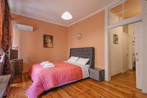 a bedroom with a bed with a red blanket at Venetian Reale Apartment in Corfu Town