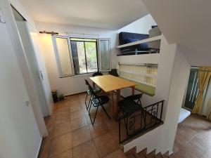 a small dining room with a table and chairs at Sea Satin Anavyssos in Anavissos