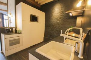 a kitchen with a sink and a counter top at Old Town apartment with view in Lille