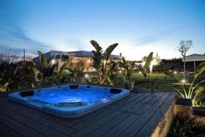 a hot tub sitting on top of a wooden deck at Cesarina Suite Apartment in Alessano