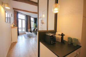 a kitchen with a counter with a toaster on a counter at Old Town apartment with view in Lille
