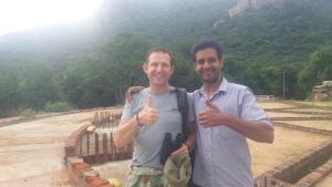 two men giving thumbs up in front of a pyramid at Tuktukraju Home stay 