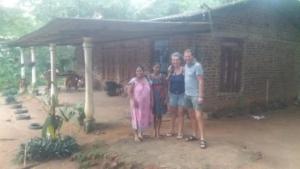 a group of people standing in front of a house at Tuktukraju Home stay 