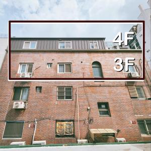 a large brick building with a sign on it at Daol Stay in Seoul